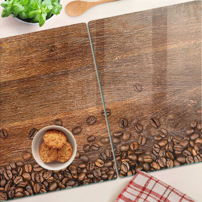 Snijplanken van glas Koffiebonen op een houten achtergrond