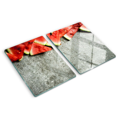 Snijplanken glas Watermeloenschijven op een grijze achtergrond