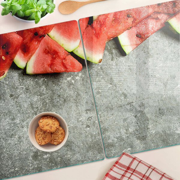 Snijplanken glas Watermeloenschijven op een grijze achtergrond