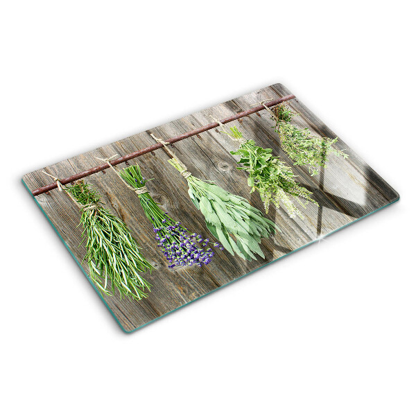 Snijplanken van glas Kruiden op een houten achtergrond