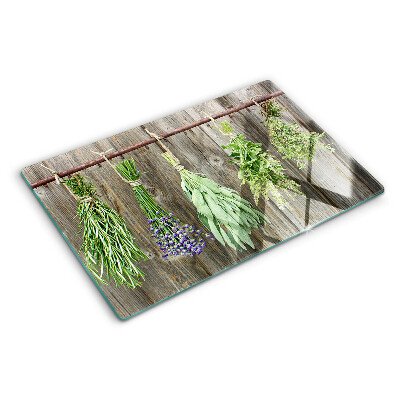 Snijplanken van glas Kruiden op een houten achtergrond