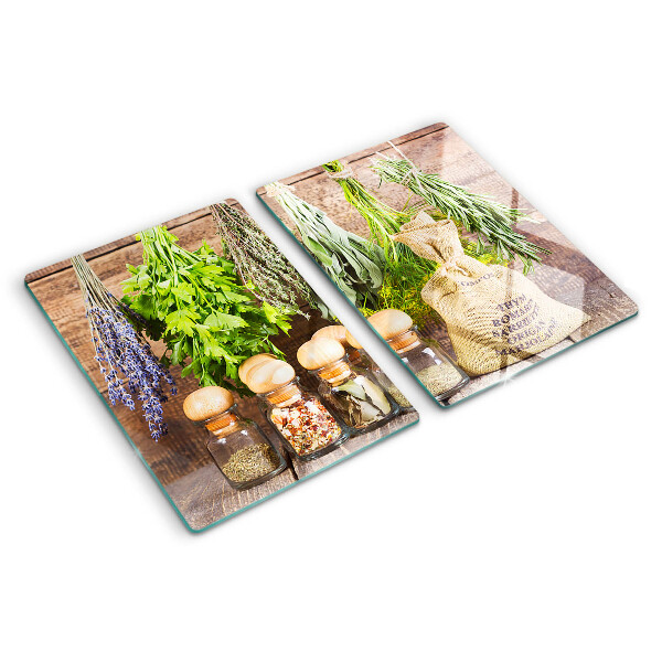 Snijplanken van glas Kruiden en specerijen op een houten achtergrond