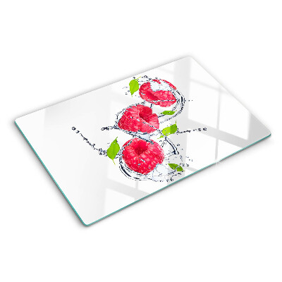 Snijplanken van glas Frambozen in water met bladeren