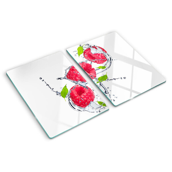 Snijplanken van glas Frambozen in water met bladeren