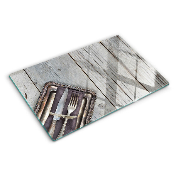 Snijplanken van glas Rustiek bestek op een houten achtergrond