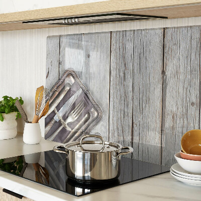 Snijplanken van glas Rustiek bestek op een houten achtergrond