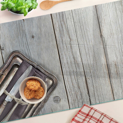 Snijplanken van glas Rustiek bestek op een houten achtergrond