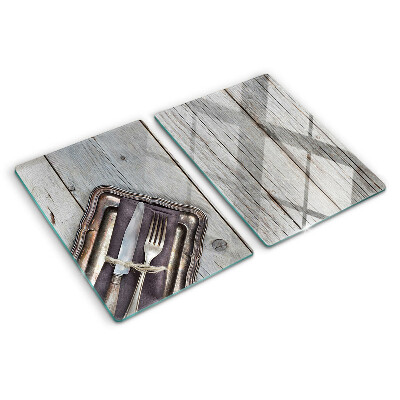 Snijplanken van glas Rustiek bestek op een houten achtergrond