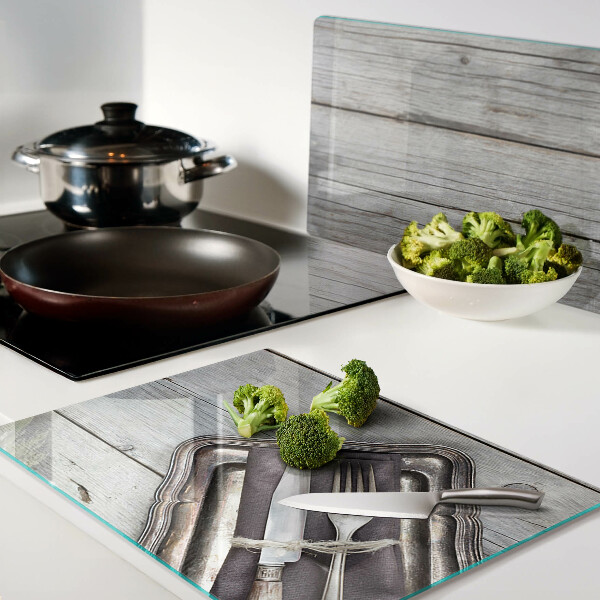 Snijplanken van glas Rustiek bestek op een houten achtergrond