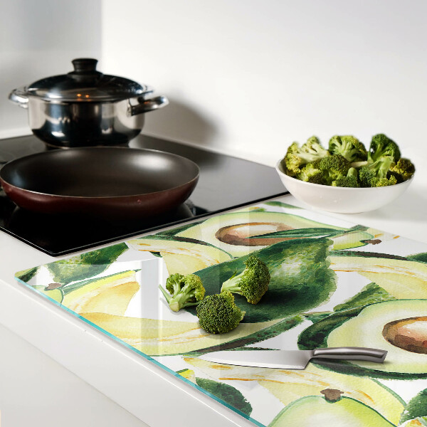 Snijplanken van glas Avocado met bladeren op de achtergrond