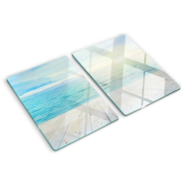 Snijplanken van glas De zee en de houten steiger