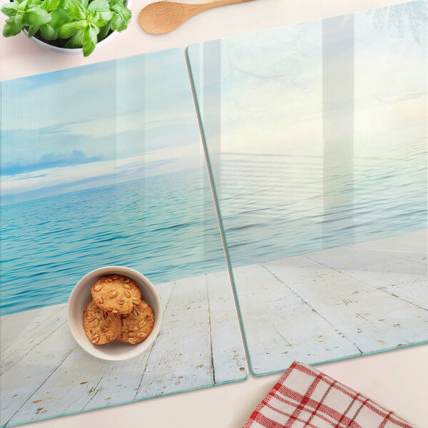 Snijplanken van glas De zee en de houten steiger