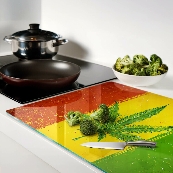 Snijplanken van glas Cannabisblad op een kleurrijke achtergrond