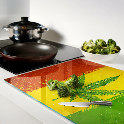 Snijplanken van glas Cannabisblad op een kleurrijke achtergrond