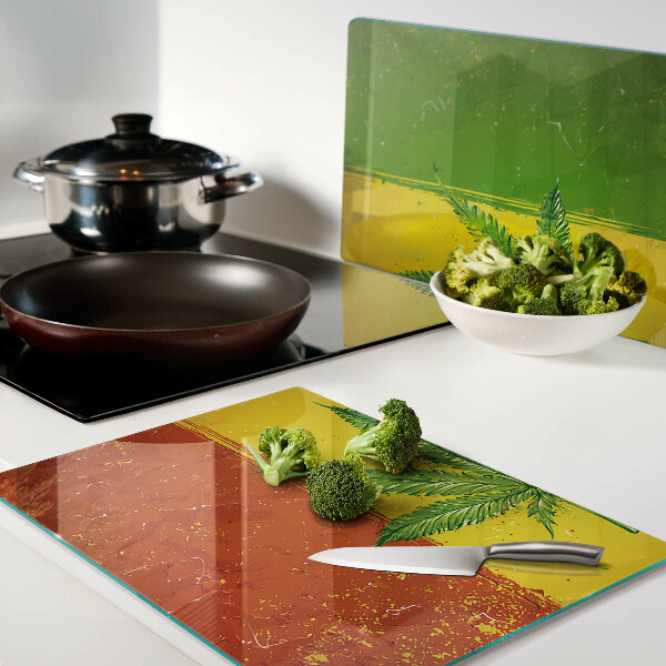 Snijplanken van glas Cannabisblad op een kleurrijke achtergrond