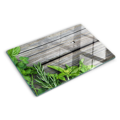 Snijplanken van glas Groene kruiden op een houten achtergrond