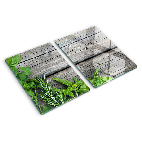 Snijplanken van glas Groene kruiden op een houten achtergrond