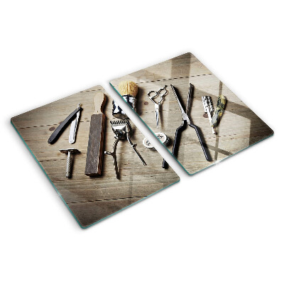 Snijplanken van glas Kappersgereedschap op een houten achtergrond