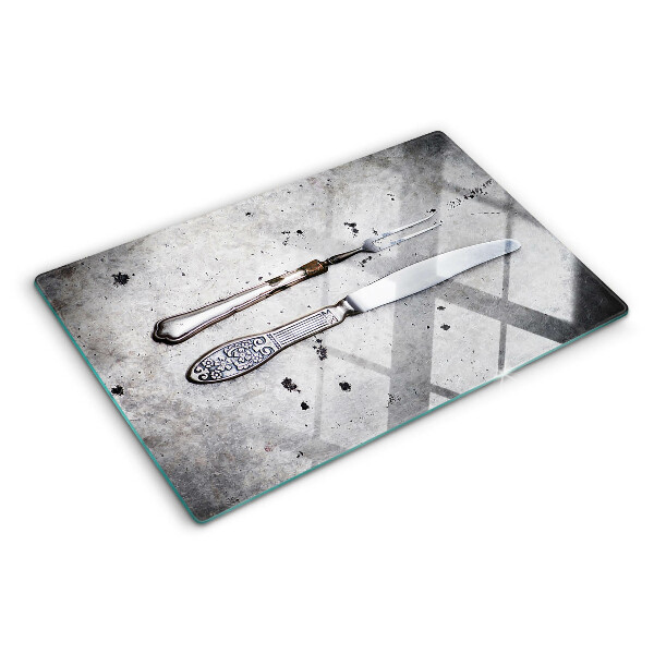Snijplanken glas Bestek op een betonnen achtergrond