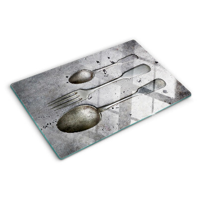 Glazen snijplanken Bestek op een betonnen achtergrond