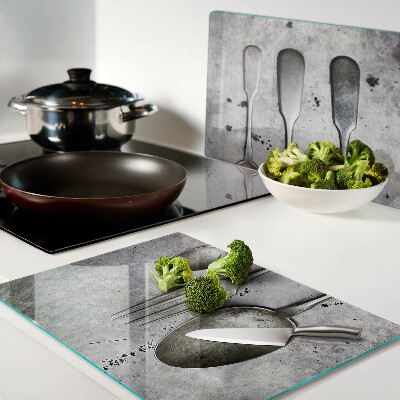 Glazen snijplanken Bestek op een betonnen achtergrond