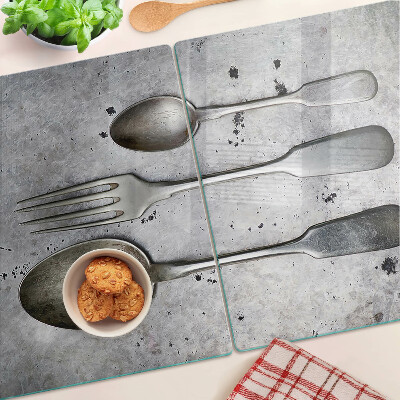 Glazen snijplanken Bestek op een betonnen achtergrond