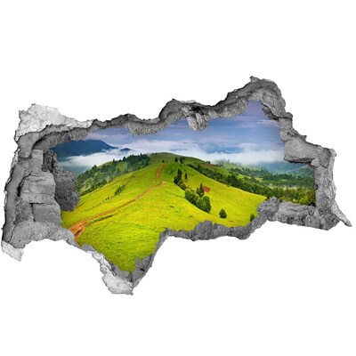 3D sticker gat in stenen muur Groene heuvels in de wolken