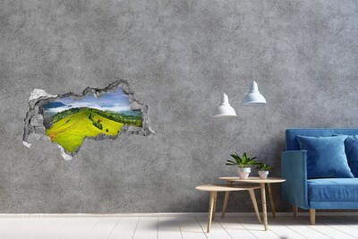 3D sticker gat in stenen muur Groene heuvels in de wolken