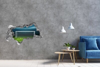 3D muursticker gescheurde muur Het voetbalstadion achter het gat in de muur.