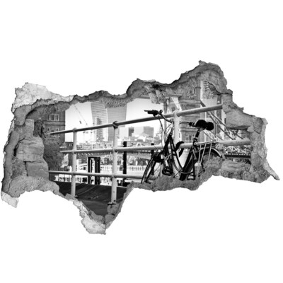 3D muursticker gescheurde muur Een fiets aan de stadskade.