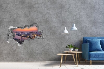 3D muursticker gescheurde muur Uitzicht op de stad bij zonsondergang
