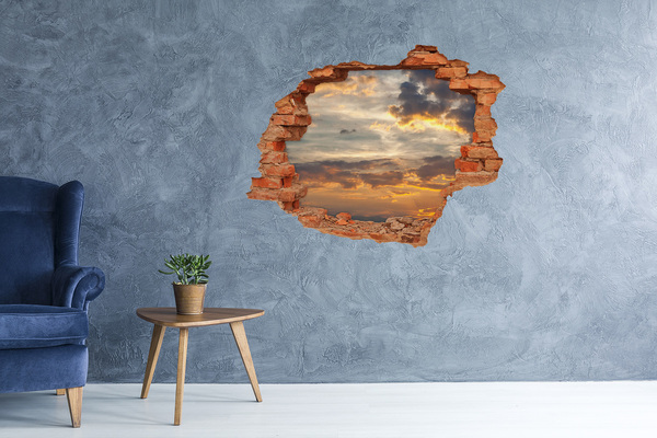 Vinyl muursticker 3D breekeffect Zonsondergang door een gat in de muur