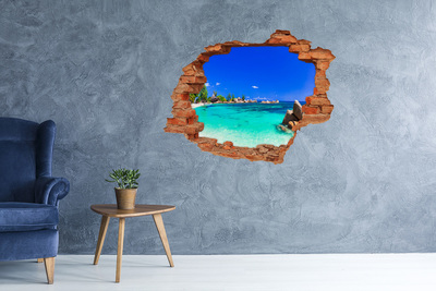 Vinyl muursticker 3D breekeffect Caribisch strand door een gat in de muur