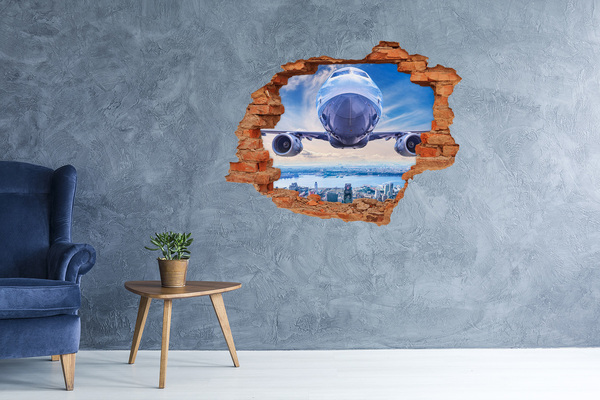 Grote 3D muursticker gat in de muur Een vliegtuig boven de stad