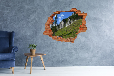 Vinyl muursticker 3D breekeffect Berglandschap door een gat in de muur