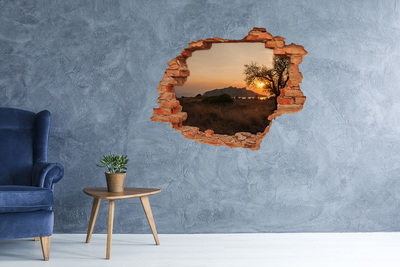 Vinyl muursticker 3D breekeffect Zonsondergang boven een berglandschap