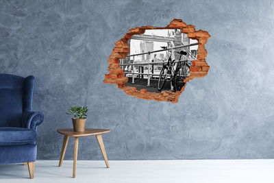 Vinyl muursticker 3D breekeffect Een fiets aan de stadskade.