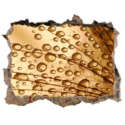 Wandsticker 3D doorkijk Een gouden druppel op een betonnen achtergrond