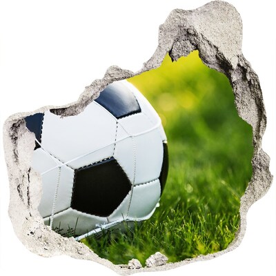 3D muursticker effect gat in de muur Voetbal op het veld