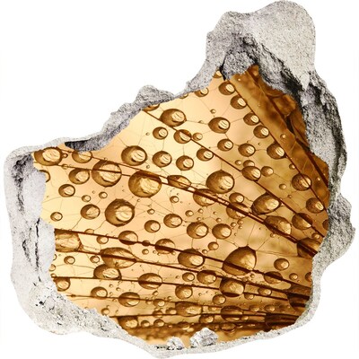 3D wandsticker gat in de muur Een gouden druppel op een betonnen achtergrond