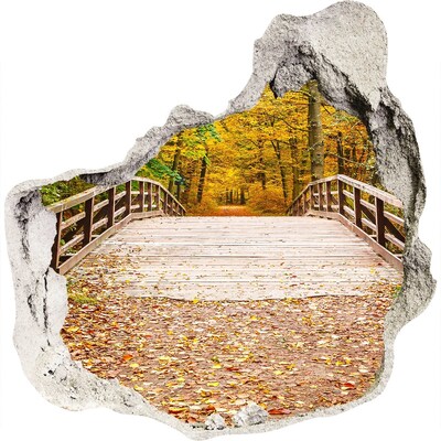 3D muursticker effect gat in de muur Een brug in een herfstbos.