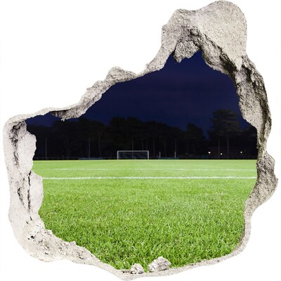 3D muursticker effect gat in de muur Voetbalveld 's nachts