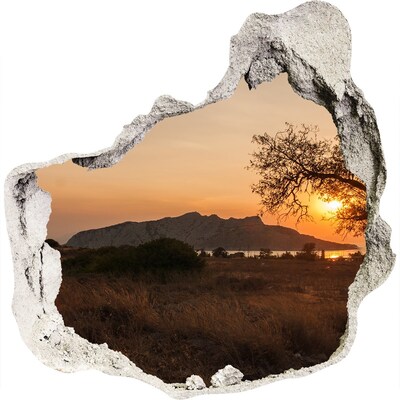 3D wandsticker gat in de muur Zonsondergang boven een berglandschap