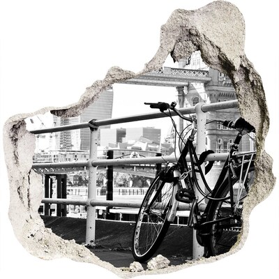 3D wandsticker gat in de muur Een fiets aan de stadskade.