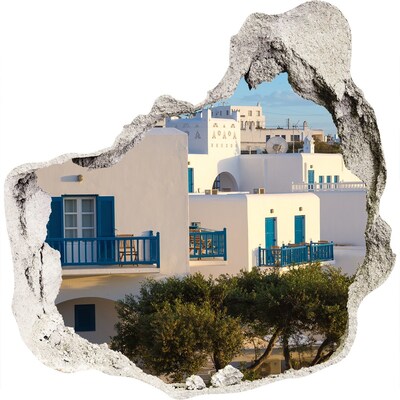 3D muursticker effect gat in de muur Uitzicht op witte huizen met blauwe ramen