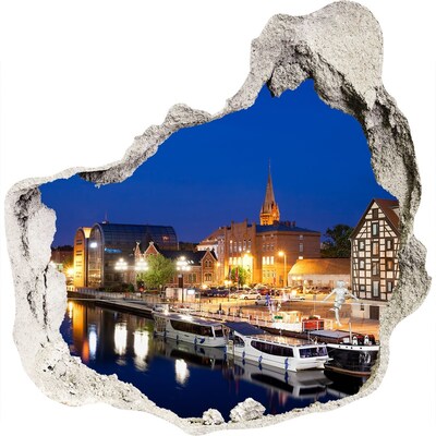 3D muursticker effect gat in de muur Nachtzicht op de stad vanaf de rivier.