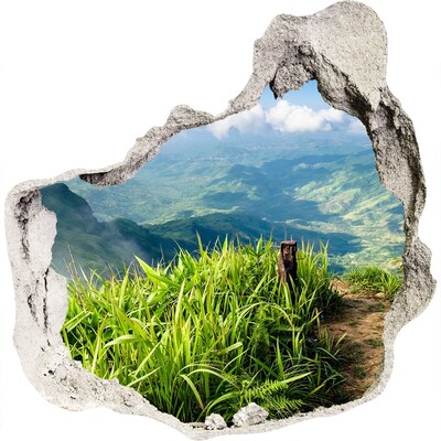 Zelfklevende muursticker 3D gat Een groene vallei in de bergen