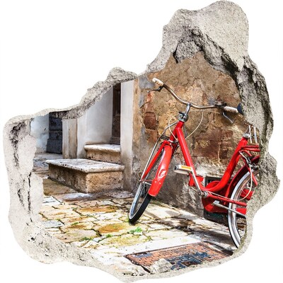 3D muursticker effect gat in de muur Een rode fiets in een charmante straat.