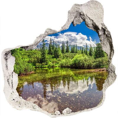 3D wandsticker gat in de muur Een groen paradijs aan de vijver.
