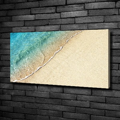 Foto canvas Een golf op het strand